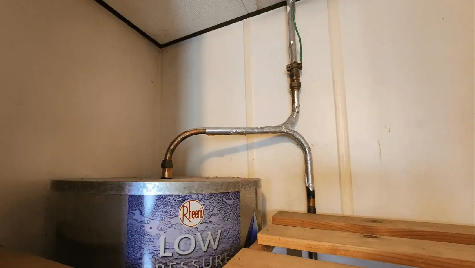 Rheem low pressure water heater with exposed pipes