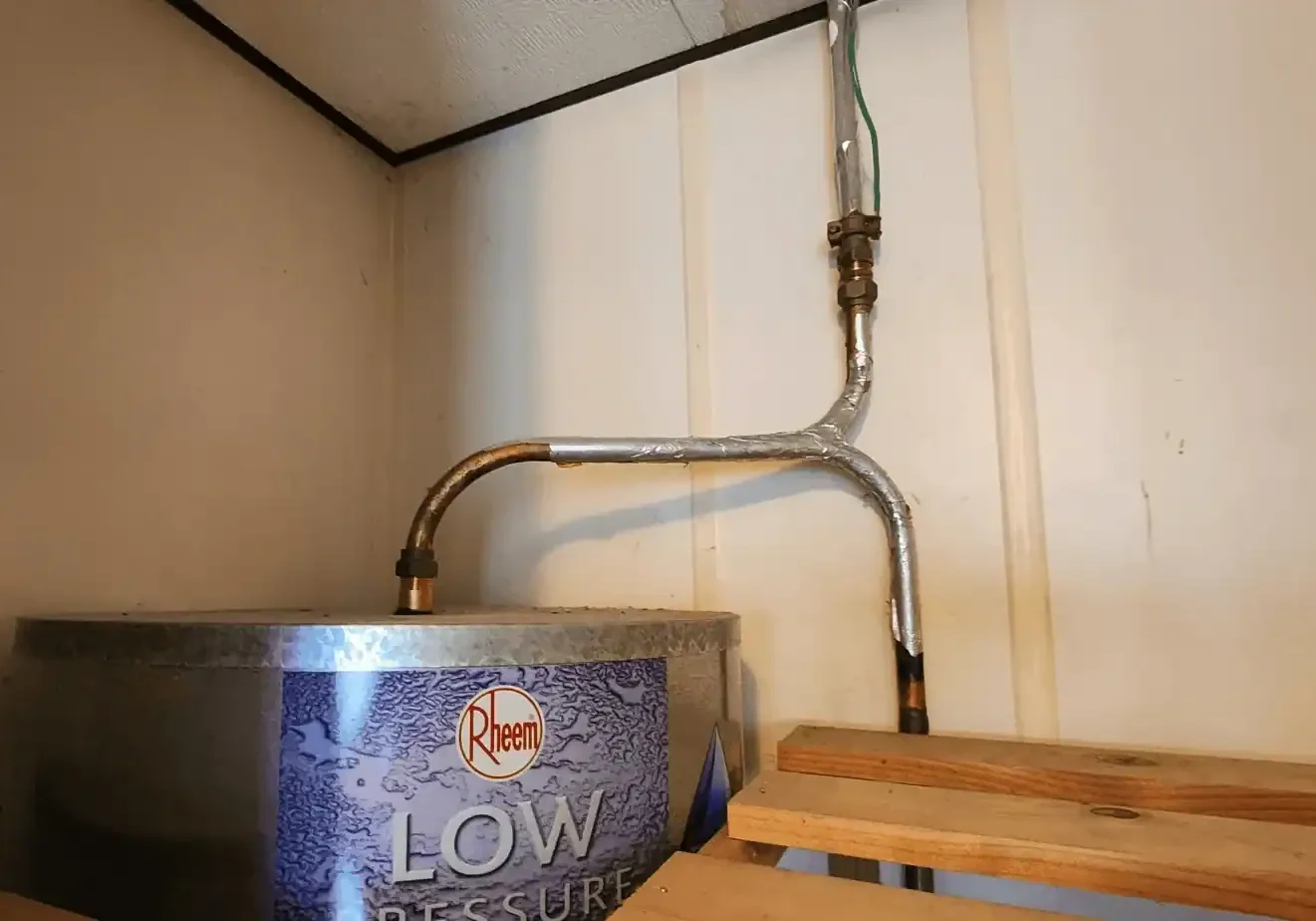 leak repairs Rheem low pressure water heater with exposed pipes
